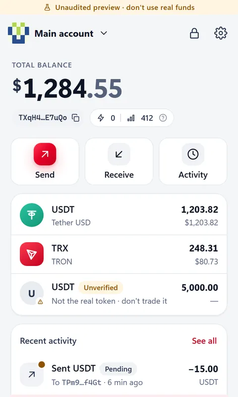 Home screen with balances and a flagged fake USDT token